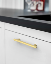 2244-brushed-gold-cabinet-handles-Installed-on-White-Cabinets