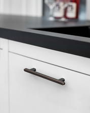 2244-oil-rubbed-bronze-cabinet-handles-Installed-on-White-Cabinets