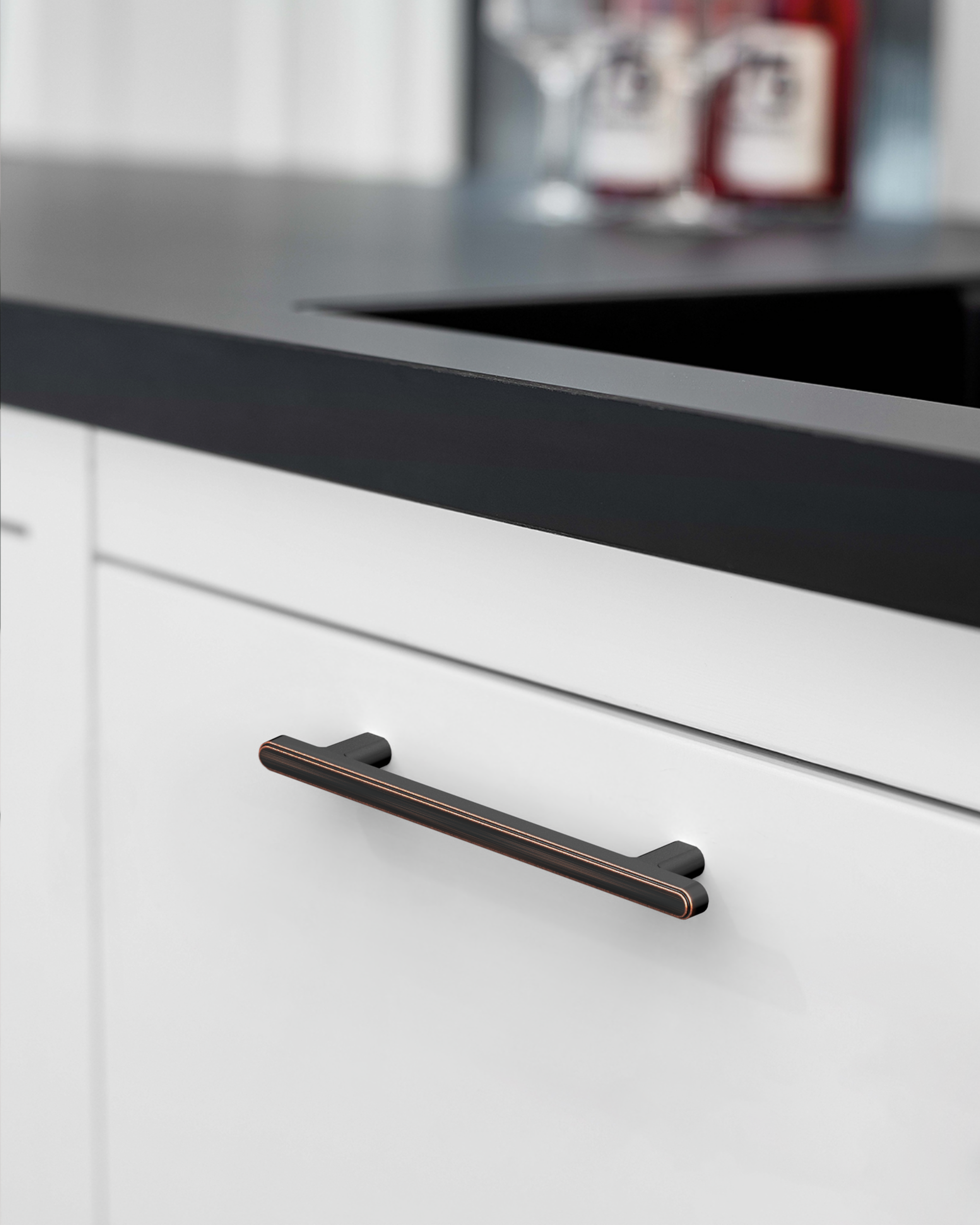 2244-oil-rubbed-bronze-cabinet-handles-Installed-on-White-Cabinets