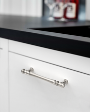 Design2322 Decorative Turned Pulls | Walnut Wood & White Raised Panel Cabinets