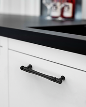 Design2322 Decorative Turned Pulls | Walnut Wood & White Raised Panel Cabinets