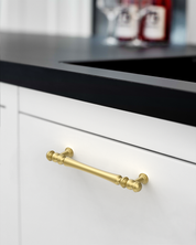 Design2322 Decorative Turned Pulls | Walnut Wood & White Raised Panel Cabinets